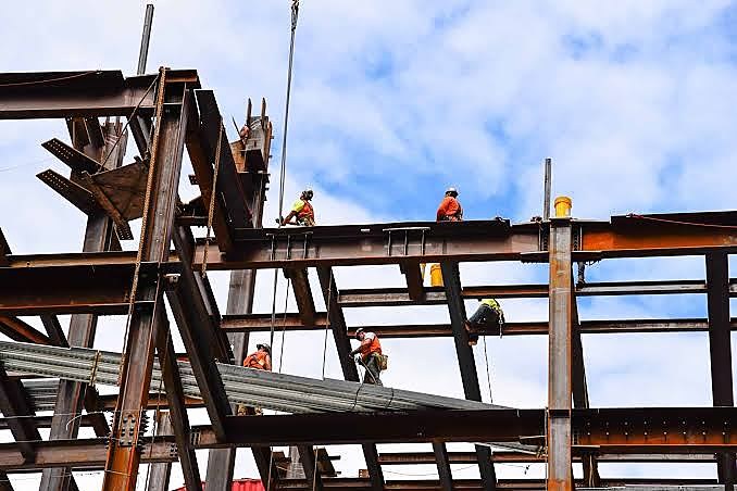 Structural steel workers on an active Africa Singatha Construction site
