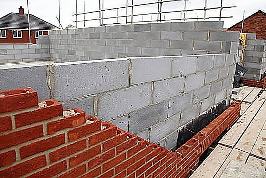 Concrete block and brick walls under construction with scaffolding