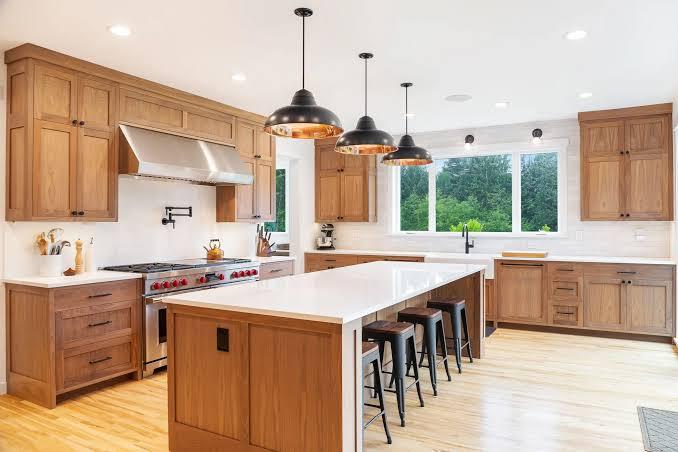 Custom wood kitchen cabinetry with island and pendant lighting