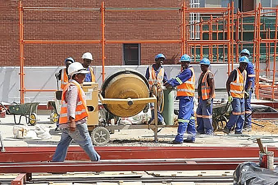 Construction team mixing concrete on an industrial building site