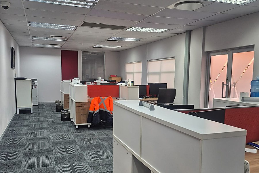 Finished office reception and workstation area with partitioned offices